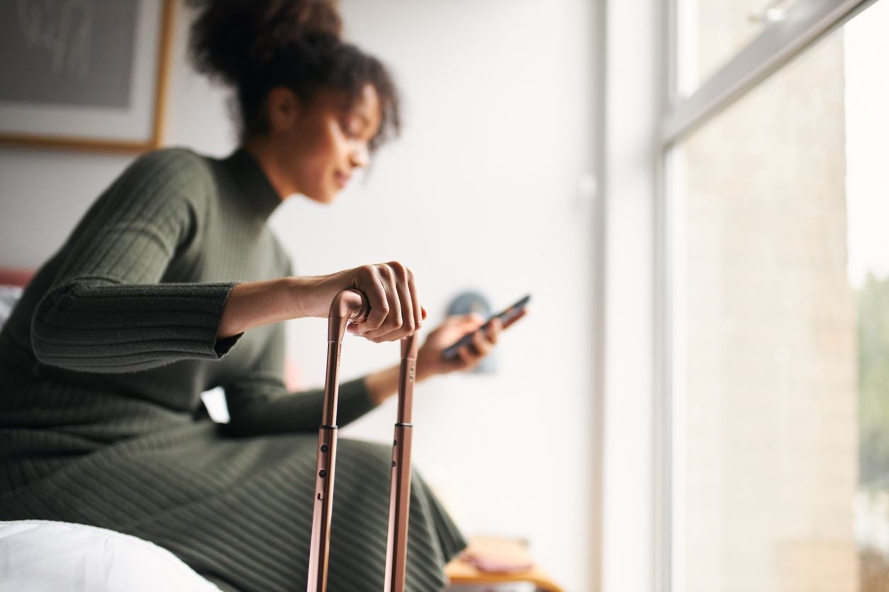 Traveler booking laundry pickup and delivery service at Nashville hotel using phone