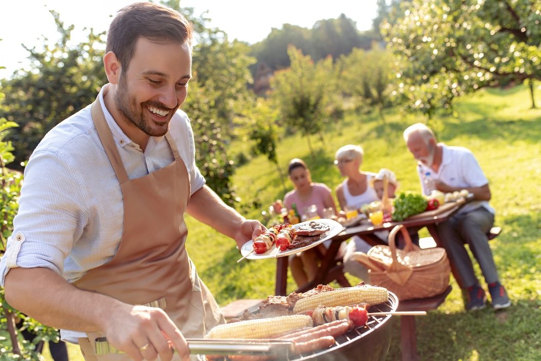 Family enjoying Labor Day cookout while saving time with busy weekend laundry in Nashville pickup and delivery.
