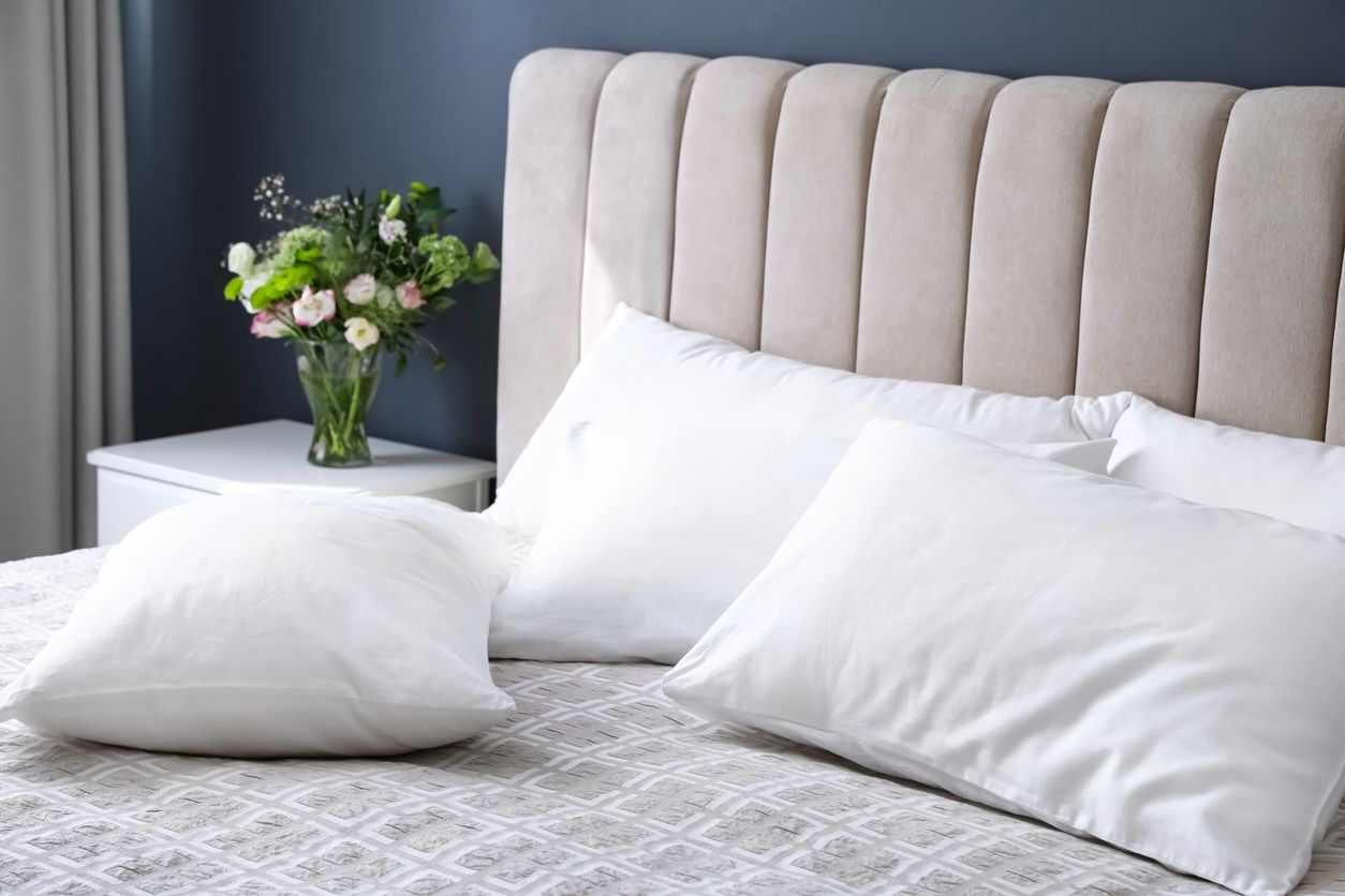 Freshly cleaned pillows on a bed after professional laundry service in Nashville